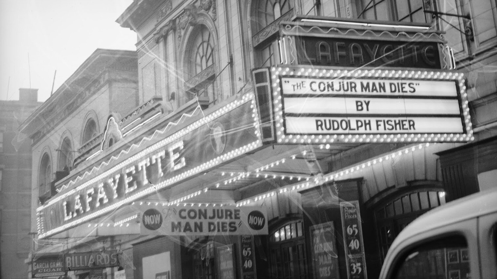 A black-and-white photo centering on the signage for the Lafayette Theatre. Two promotion signs read “‘The Conjur Man Dies' by Rudolph Fisher.” 