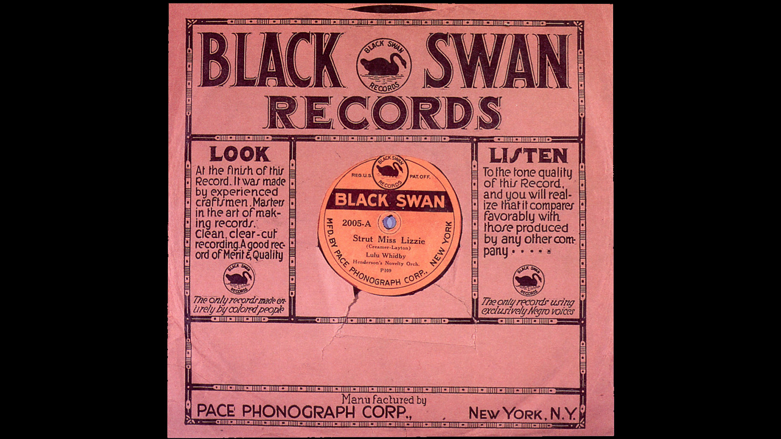 A photo of a record inside of a record sleeve. The sleeve says “Black Swan Records” in large black print at the top; the image of a Black swan in a circle is nestled within the record label wording. The open circle of the sleeve shows a light orange label for a song “Strut Miss Lizzie” by Lulu Whidby. 